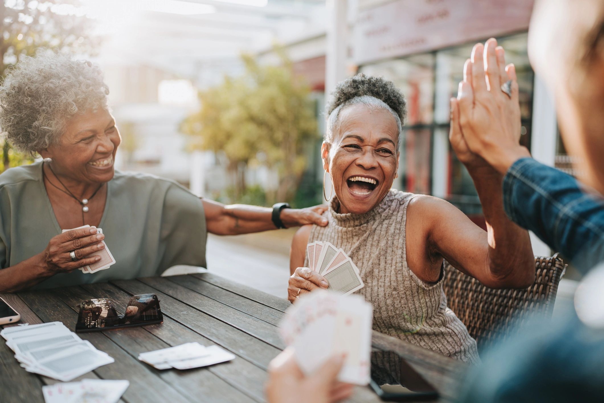 Diverse older adults playing cards and laughing